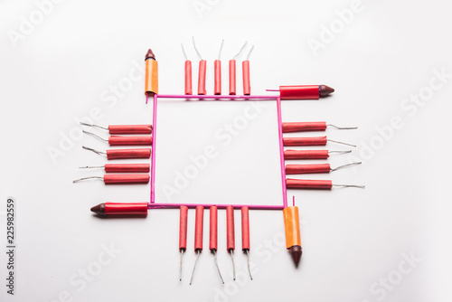 Diwali Firecrackers along with Clay oil lamp or Diya arranged over white background to create a beautiful rangoli or design photo