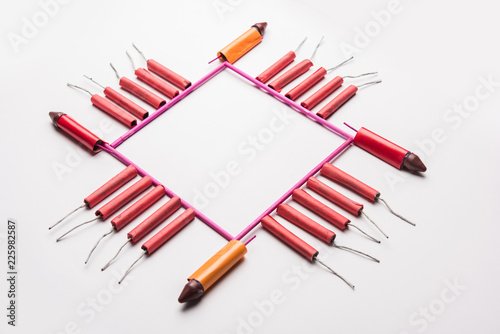 Diwali Firecrackers along with Clay oil lamp or Diya arranged over white background to create a beautiful rangoli or design photo