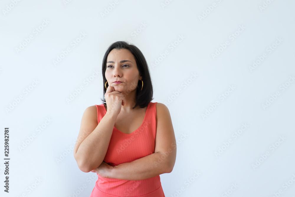 Pensive attractive Caucasian woman holding chin and frowning. Pretty middle aged female model looking sideways in thought. Making decision concept. Pensive attractive Caucasian woman holding chin and frowning. Pretty middle aged female model looking sideways in thought. Making decision concept.