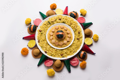 Rangoli or design made using Indian snacks/sweet and firecrackers or patakhe for Diwali festival  photo