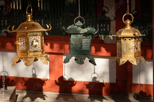 Three japanese lanterns and their shadows in the late afternoon sun