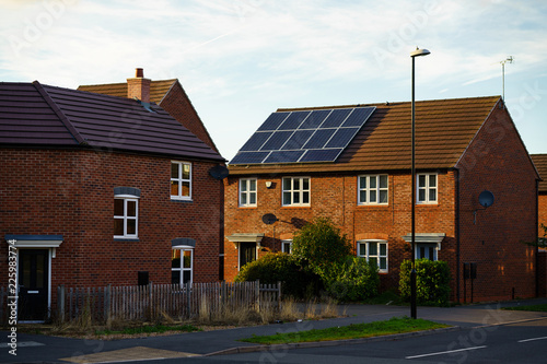 Solar photovoltaic panels mounted on a tiled new familiy houses roof, England © nrqemi