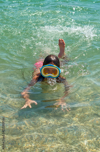 Beautiful Young Girl Diving at sea