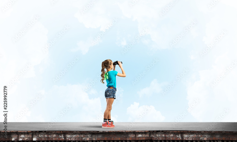 Concept of careless happy childhood with girl of school age looking in future Concept of careless happy childhood with girl of school age looking in future