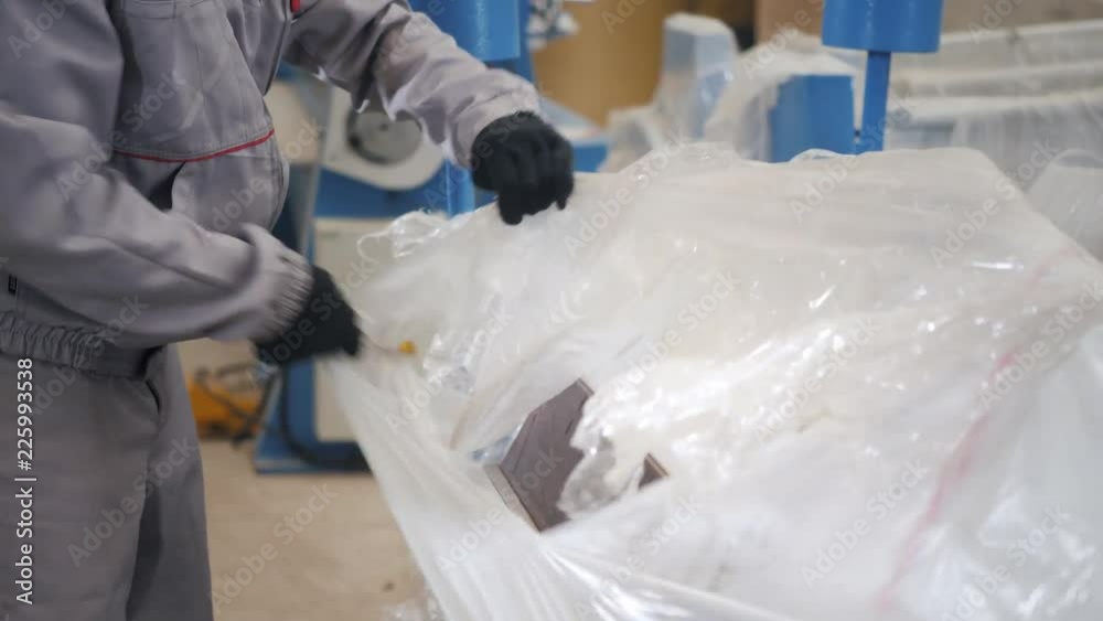manufacture workshop. Worker unpacks the machine in the warehouse. the production of ventilation and gutters. Tool and bending equipment for sheet metal. manufacture workshop. Worker unpacks the machine in the warehouse. the production of ventilation and gutters. Tool and bending equipment for sheet metal.