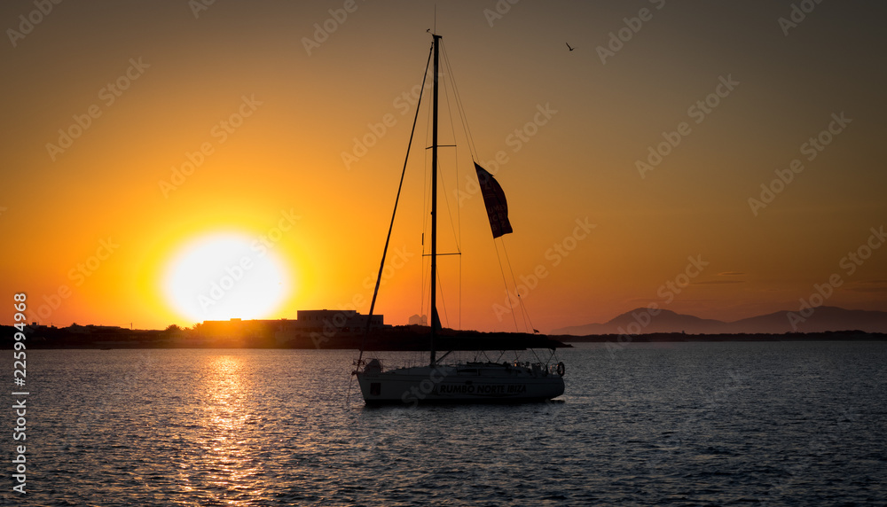 sailing boat silhouette at orange sunset