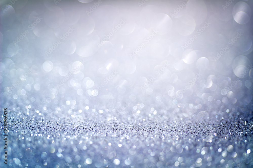 Abstract blue glitter bokeh background with shimmering light bubbles