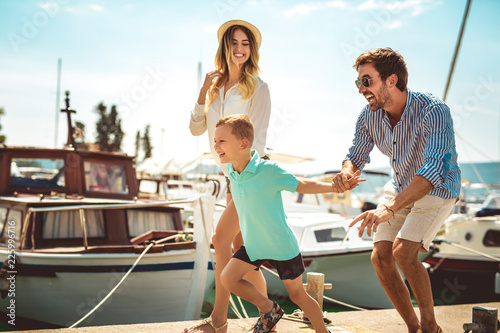 Happy family having fun, enjoying the summer time by the sea. © Mediteraneo