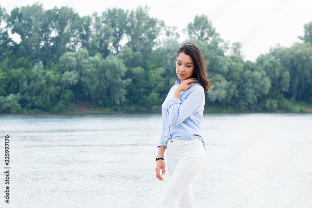 Beautiful Asian brunette woman near the river in nature Beautiful Asian brunette woman near the river in nature