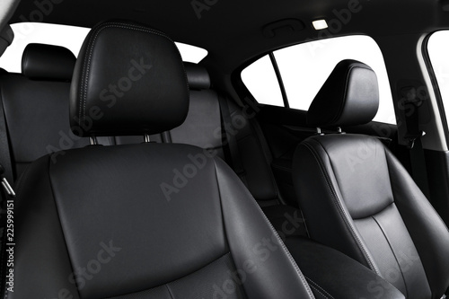 Modern luxury car black leather interior. Part of leather car seat details with stitching. Interior of prestige car. Comfortable perforated leather seats. Black perforated leather. Car detailing © Aleksei