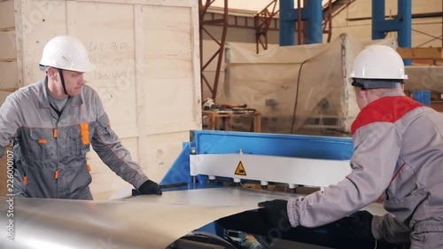 manufacture workshop. Workers adjusts the machine in the warehouse. the production of ventilation and gutters. Tool and bending equipment for sheet metal.