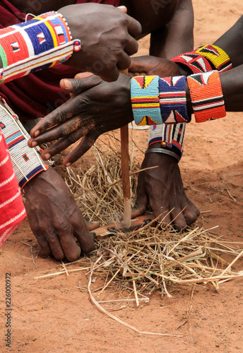 Kenya, Tsavo East - masai people setting the fire by their hands