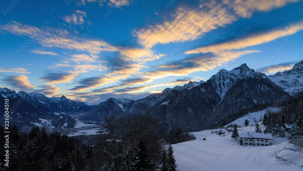 Beautiful 4k UHD timelapse video of the sun and clouds at sunrise in the Brandnertal in the mountains of the Alps in Vorarlberg, Austria, in winter with snow Beautiful 4k UHD timelapse video of the sun and clouds at sunrise in the Brandnertal in the mountains of the Alps in Vorarlberg, Austria, in winter with snow