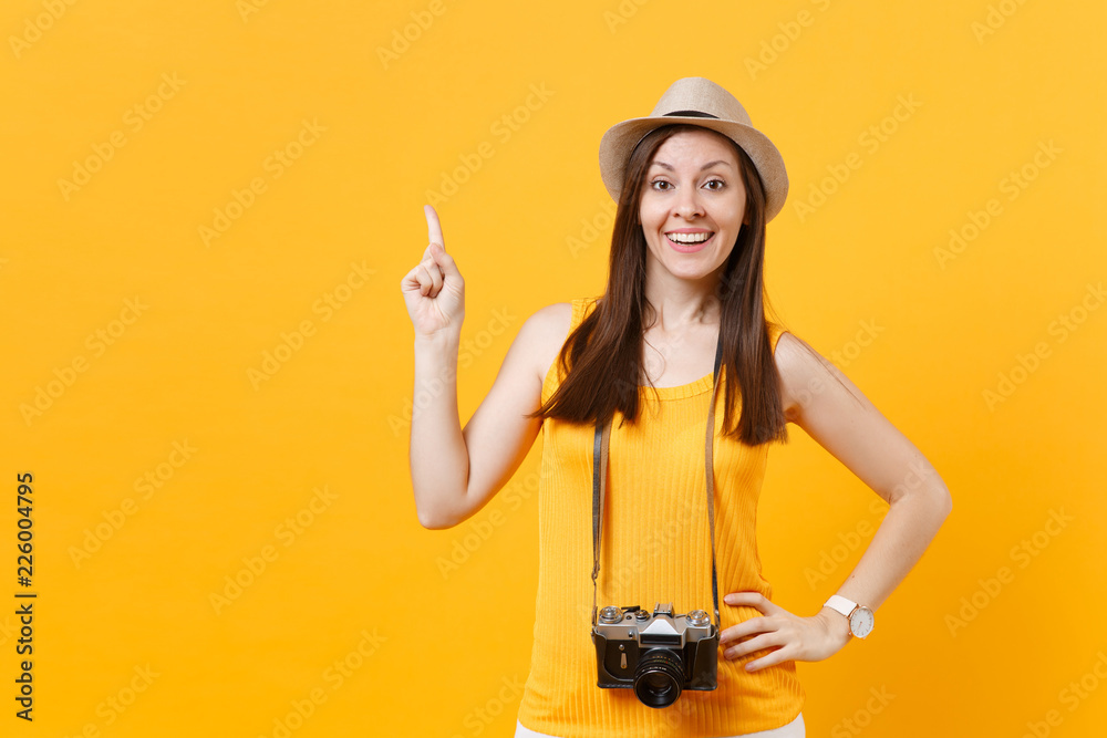 Happy traveler tourist woman in summer casual clothes, hat with retro vintage photo camera isolated on yellow orange background. Girl traveling abroad travel on weekends getaway. Air flight concept. Happy traveler tourist woman in summer casual clothes, hat with retro vintage photo camera isolated on yellow orange background. Girl traveling abroad travel on weekends getaway. Air flight concept.