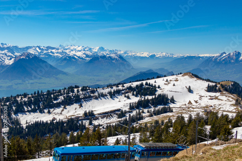 view of alpine train running in beautiful alps mountain switzerland europe on calm sunny day