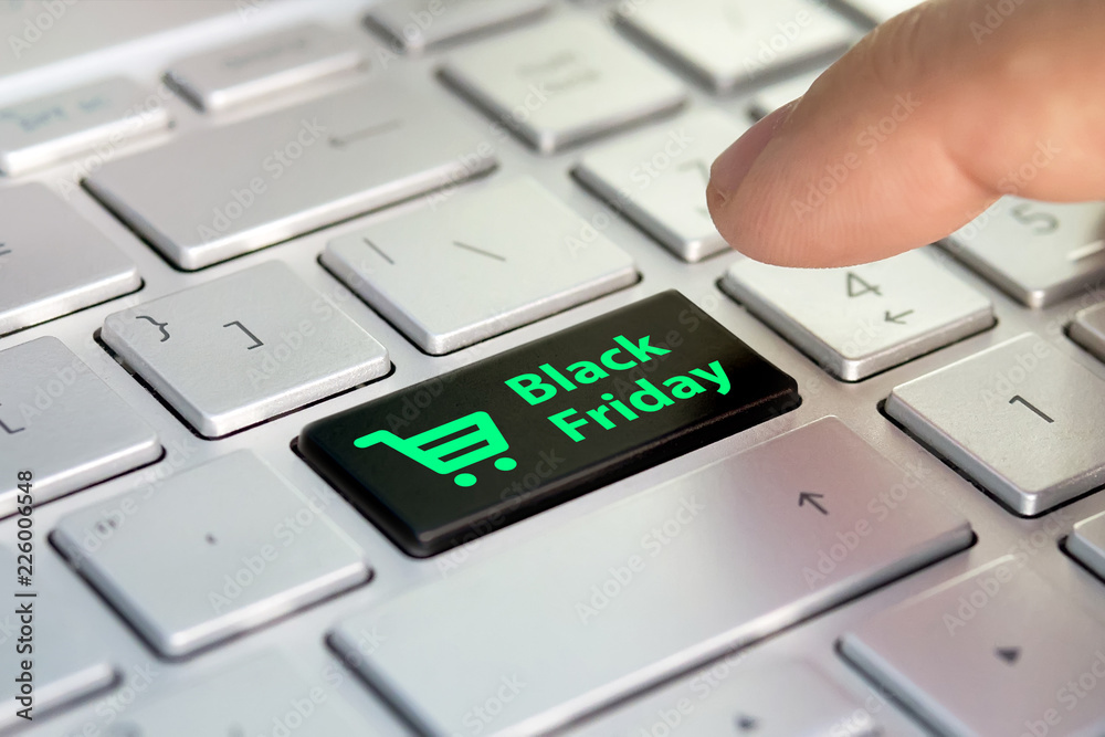 Black friday text and shopping cart on keyboard. Black friday concept. black  button on the gray silver keyboard of modern ultrabook. caption on the  button Stock Photo | Adobe Stock