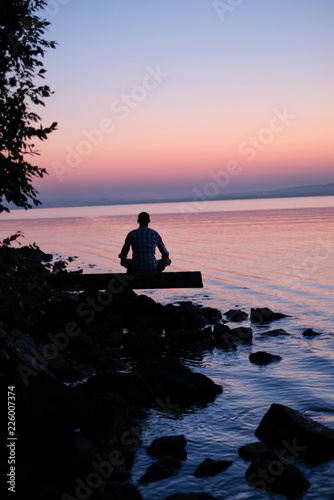 maditation man on the coast, sunset photo