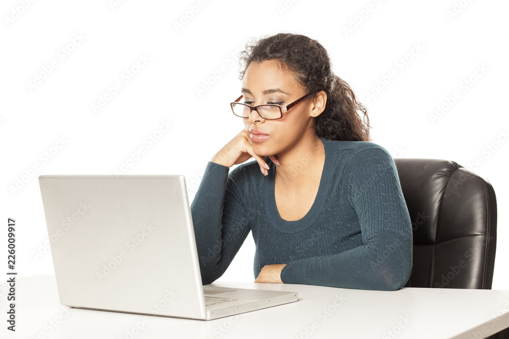 young african-american woman with beautiful face using laptop computer, working project at desk on white background young african-american woman with beautiful face using laptop computer, working project at desk on white background