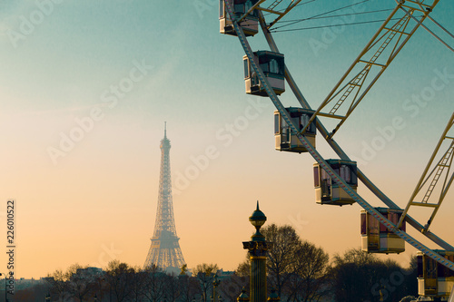 Paris, France, view on Concord square - observation wheel, Eiffel tower in the evening sunset sun rays. Selective focus © Studio Dagdagaz