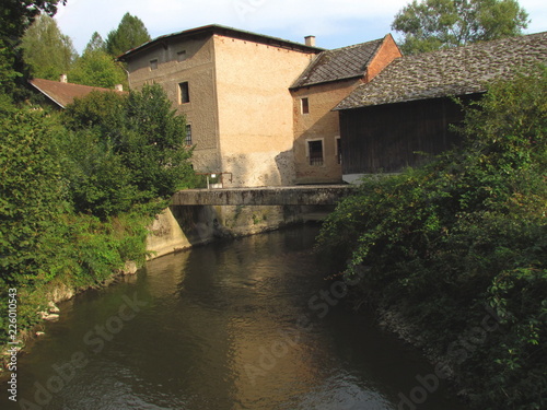 Old water saw with millrace near the river, old technical building