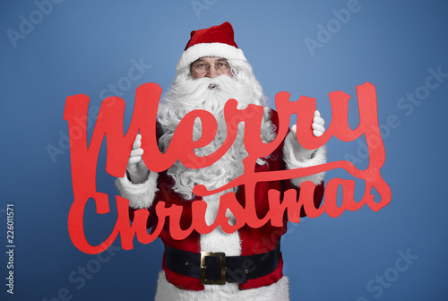 Фотография Santa Claus with christmassy banner