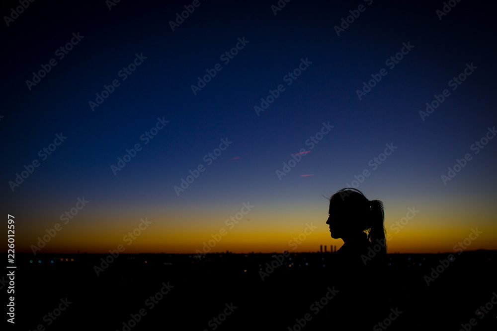 silhouette of woman in sunset