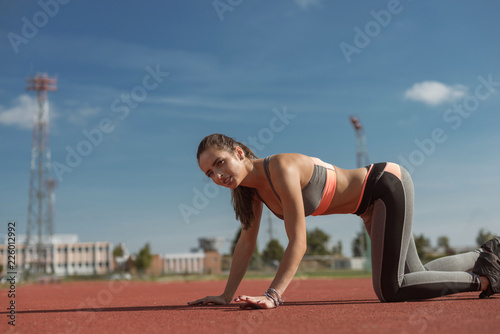 Young Female Athlete on the tracks on a sunny day.