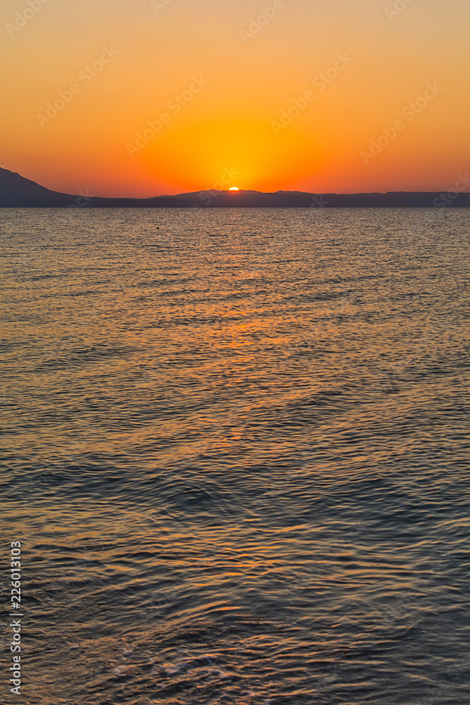 Fototapeta premium Early morning , dramatic sunrise over sea and mountain. Photographed in Asprovalta, Greece.