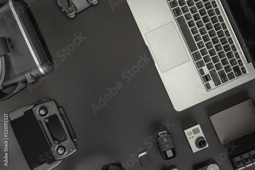 Work space professional photographer flight kit on quadcopter with VR glasses. Top view on black table background. Concept of mockup template.