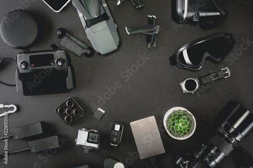 Work space professional photographer flight kit on quadcopter with VR glasses. Top view on black table background. Concept of mockup template.