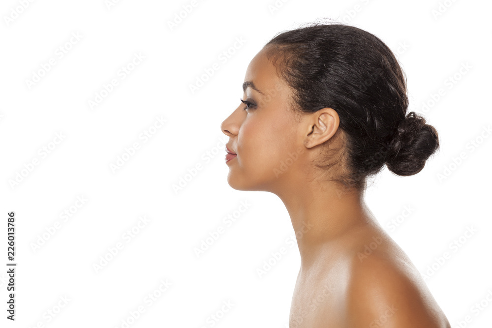 profile of young beautiful dark-skinned woman with bun on a white background profile of young beautiful dark-skinned woman with bun on a white background