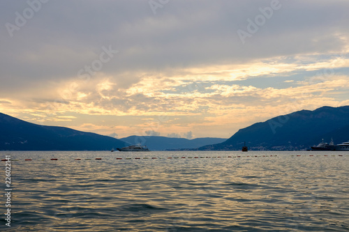 Sailboat in the sea in the evening sunlight over beautiful big mountains background  luxury summer adventure  active vacation in Tivat  Montenegro