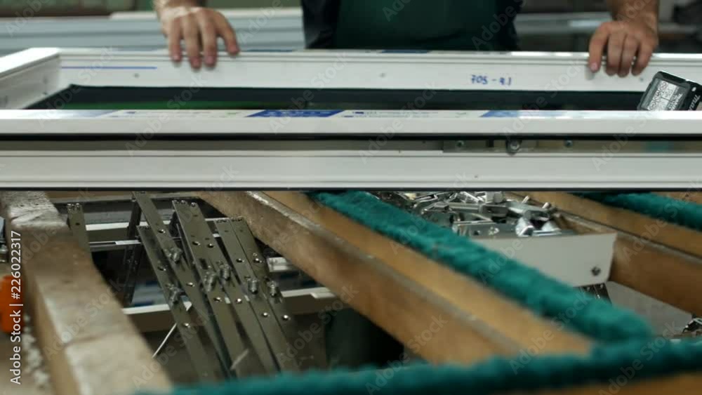 Production and manufacturing of pvc windows, male worker produces pvc window assembly collects sash windows, pvc profile worker Production and manufacturing of pvc windows, male worker produces pvc window assembly collects sash windows, pvc profile worker