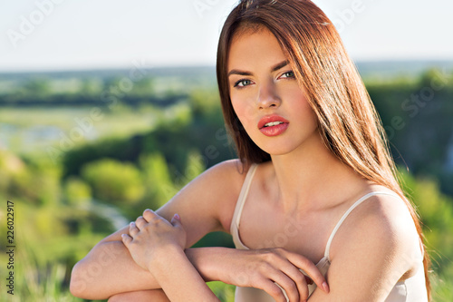 Portrait of a young woman outdoors.