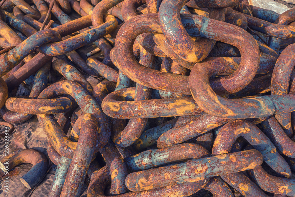 Rusty tangled chains lie in the port. Background. Metal corrosion Rusty tangled chains lie in the port. Background. Metal corrosion