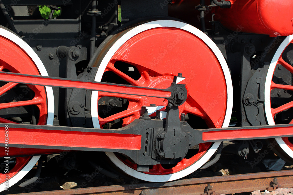 Red painted wheels of a steam locomotive