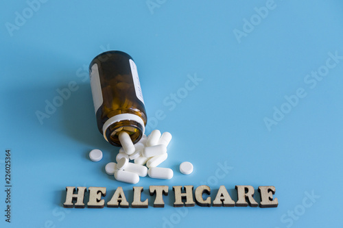inscription healthcare and pills on a blue background