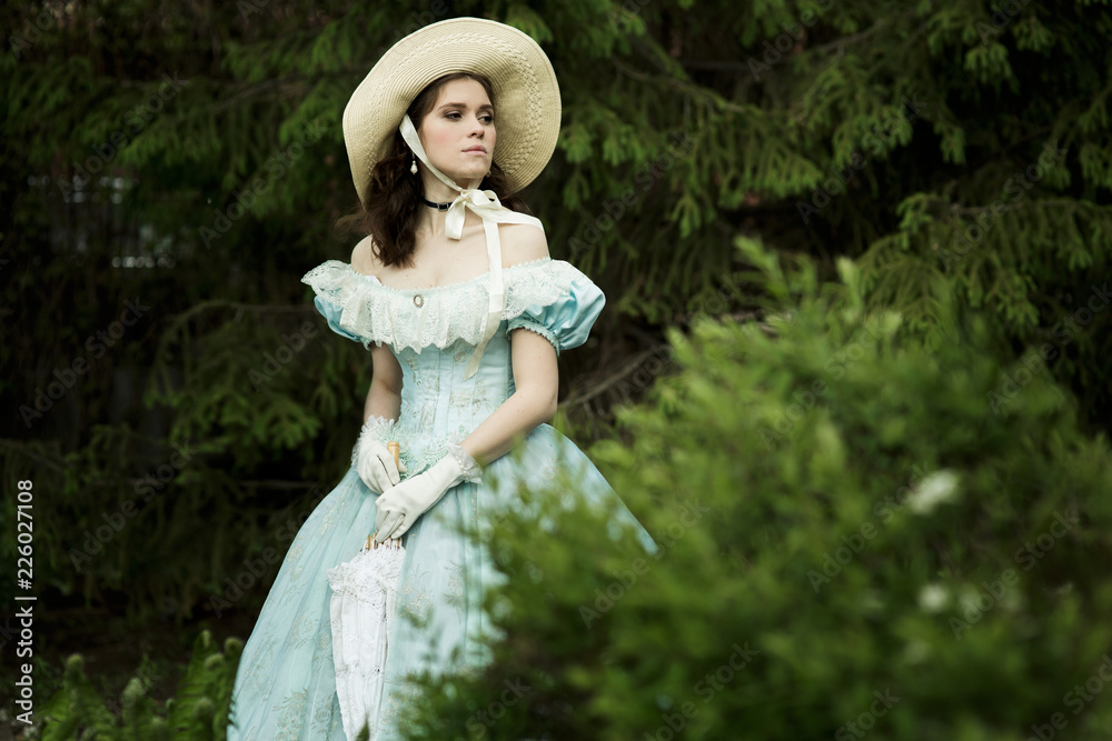 beautiful girl in historical dress gloves with an umbrella in