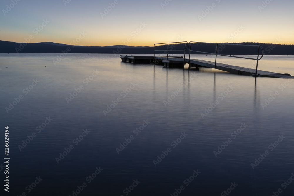 A dock on Lake Almanor, California during sunrise