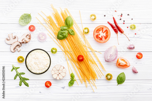 Ingredients for homemade pasta on wooden background.