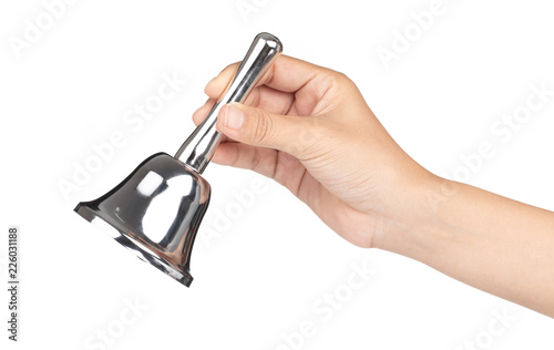 hand holding silver hand bell isolated on a white background. photo