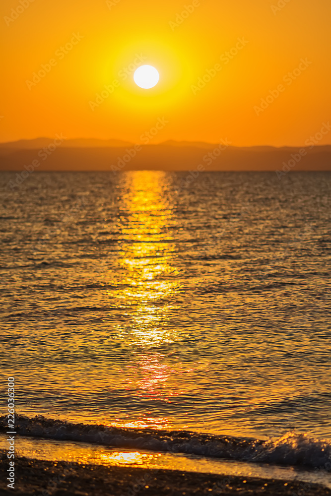 Fototapeta premium Early morning , dramatic sunrise over sea and mountain. Photographed in Asprovalta, Greece.
