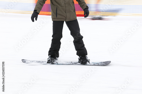 A guy is riding a snowboard from a mountain in winter