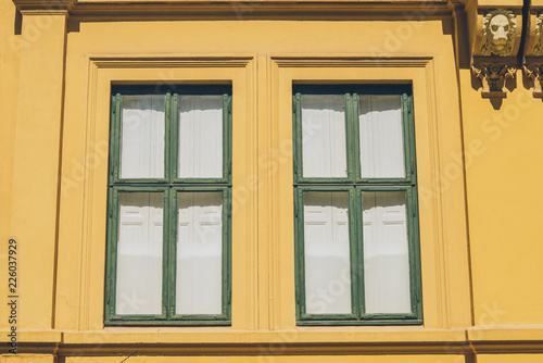 old yellow house with sculptures and windows in oslo  norway  full frame view