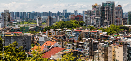Great panoramic view of the urban landscape of Macau, one of the most densely populated territory worldwide. The idiosyncratic residential buildings tell a history of cohabitation between East & West.