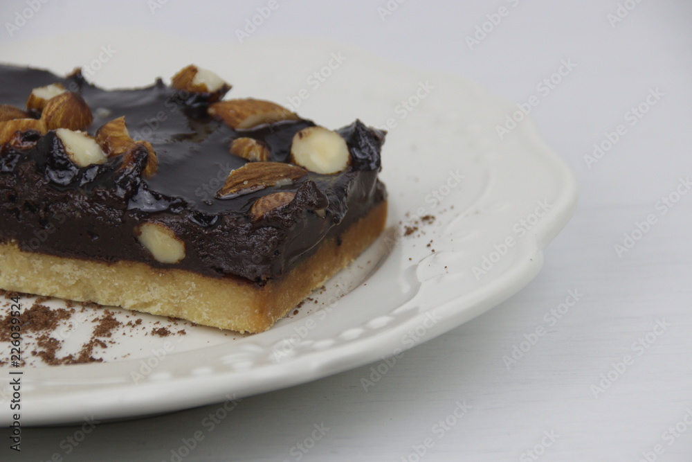 Almond Chocolate Brownie on White Ceramic Plate Almond Chocolate Brownie on White Ceramic Plate