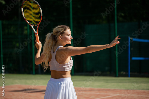 Advanced female player returns a ball during second set of international tournament