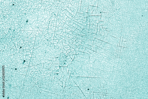Crack and damage on painted texture in cyan tone.