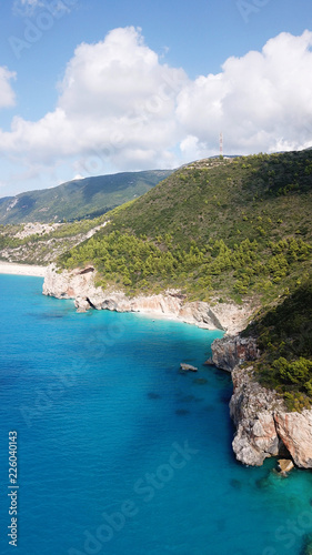 Aerial top view photo of sun beds in popular tropical paradise deep turquoise sandy beach of Kathisma, Lefkada island, Ionian, Greece