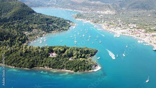 Aerial drone bird's eye view photo of iconic port of Nidri or Nydri a safe harbor for sail boats and famous for trips to Meganisi, Skorpios and other Ionian islands, Leflkada island, Ionian, Greece © aerial-drone